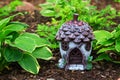 Little gnome cottage among hostas in a shade garden Royalty Free Stock Photo