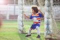 Little goalkeeper used hands for catches the ball in match game