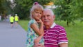 Little grandchild girl embracing kissing with her grandfather in park, happy family relationship Royalty Free Stock Photo