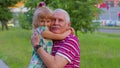 Little grandchild kid embracing kissing with her grandfather in park, happy family relationship Royalty Free Stock Photo