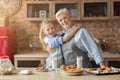 Little granddaughter hugging her happy grandmother during lunch time Royalty Free Stock Photo