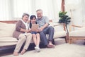 Little granddaughter teach senior elder to surf internet using tablet and technology& modern lifestyle.Digital life with stay at Royalty Free Stock Photo