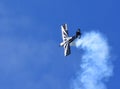 American Champion 8KCAB Decathlon aircraft stunt flying with smoke.