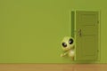 A little green monster at back on the door,3D illustration. Royalty Free Stock Photo
