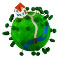 Little green planet with toy house. Royalty Free Stock Photo