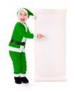 Little green Santa Claus boy pointing at big wish list Royalty Free Stock Photo