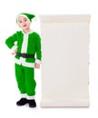 Little green Santa Claus standing near big wish list Royalty Free Stock Photo