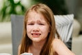 Little grimy girl cries at the dinner table. The child refuses to eat. Royalty Free Stock Photo