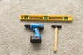 Construction concept - Hammer, screwdriver and builders level on the floor, top view Royalty Free Stock Photo