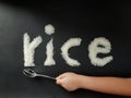 The little hand of Asian boy pretent to use a spoon toeat rice Royalty Free Stock Photo