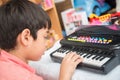 Little hand boy playing small keyboard practice indoor