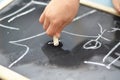 Little hand is drawing on chalk board