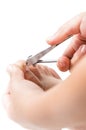 Little hand use a nail cliper to cut toenail Royalty Free Stock Photo