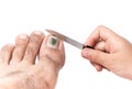 Little hand use a nail file to clean toenail Royalty Free Stock Photo