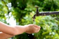 Little hand wait for water drop from faucet Royalty Free Stock Photo