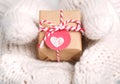 Little handmade gift box in hands with gloves Royalty Free Stock Photo