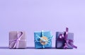 Little handmade present boxes on purple Royalty Free Stock Photo