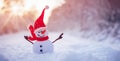 Little handmade snowman on the white snow on snowy background.