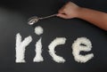 The little hands of Asian boy pretent to use a spoon to eat rice Royalty Free Stock Photo