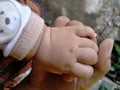 Family concept protection and happiness, the baby`s hand is held by the mother