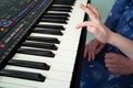 Little hands black white piano keys synth close-up Royalty Free Stock Photo