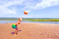 Little boy plays ball on the beach. Royalty Free Stock Photo