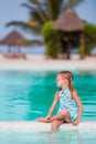Little happy adorable girl on the edge of outdoor pool Royalty Free Stock Photo
