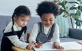 Little happy African black boy and caucasian sweet girl wearing casual sweaters, smiling, sitting together in living room at home Royalty Free Stock Photo