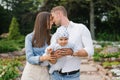 Little happy baby in the arms of loving parents in the summer in the park Royalty Free Stock Photo