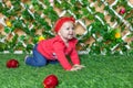 Little happy baby girl crawling on the grass in the park and smiling Royalty Free Stock Photo