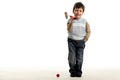 Little happy boy plays mini golf