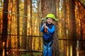 Little happy child boy in adventure park in safety equipment in summer day. Royalty Free Stock Photo