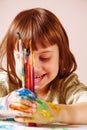 Little happy child girl painting with a brushes. Art, creativity, beauty childhood concept Royalty Free Stock Photo