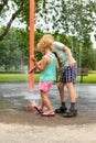 Little children playing at water splash pad fountain in park playground on hot summer day Royalty Free Stock Photo