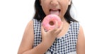 Little happy cute girl is eating donut isolated Royalty Free Stock Photo