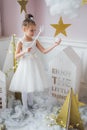 Little happy fairy or angel with magic wand on Holiday theme. Portrait of pretty caucasian little angel wearing white Royalty Free Stock Photo