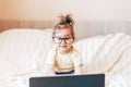 Little happy funny black-haired girl using laptop Royalty Free Stock Photo