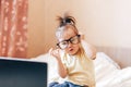 Little happy funny black-haired girl using laptop