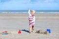 Little happy girl building sand castles on the beach Royalty Free Stock Photo