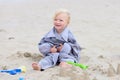 Little happy girl building sand castles on the beach Royalty Free Stock Photo