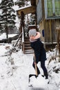 Little happy girl cleans snow near a his rural house Royalty Free Stock Photo