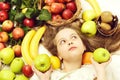 Little happy girl or cute hungry child eating colorful fruit Royalty Free Stock Photo