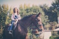 Little happy girl enjoying in riding horse Royalty Free Stock Photo