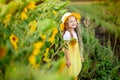 Little happy girl in a field with sunflowers in summer Royalty Free Stock Photo