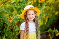 Little happy girl in a field with sunflowers in summer Royalty Free Stock Photo