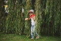 Little girl hiding in the willow foliage Royalty Free Stock Photo