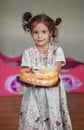 The little happy girl holds her holiday cake. Bright, delicious cake for the birthday Royalty Free Stock Photo