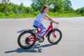 A little happy girl learns to ride a bike in the park Royalty Free Stock Photo