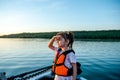 Little happy girl in a life jacket while walking on a boat Royalty Free Stock Photo