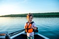 Little happy girl in a life jacket while walking on a boat Royalty Free Stock Photo